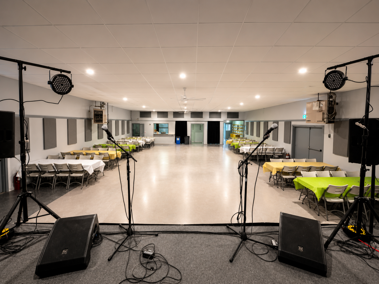 Full view of Montney Hall from the stage showing the spacious venue with tables set up