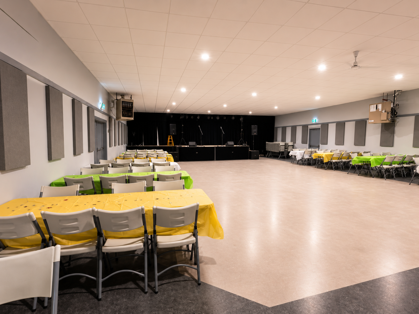 Inside Montney Hall — spacious venue with tables set up and stage in background