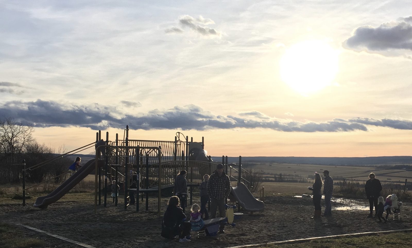 Families at the Montney playground at sunset
