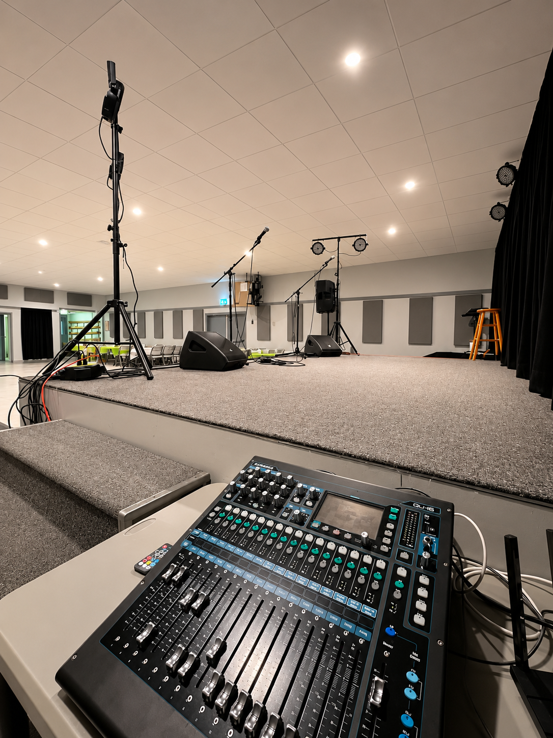 Professional mixing board and sound equipment on stage at Montney Hall